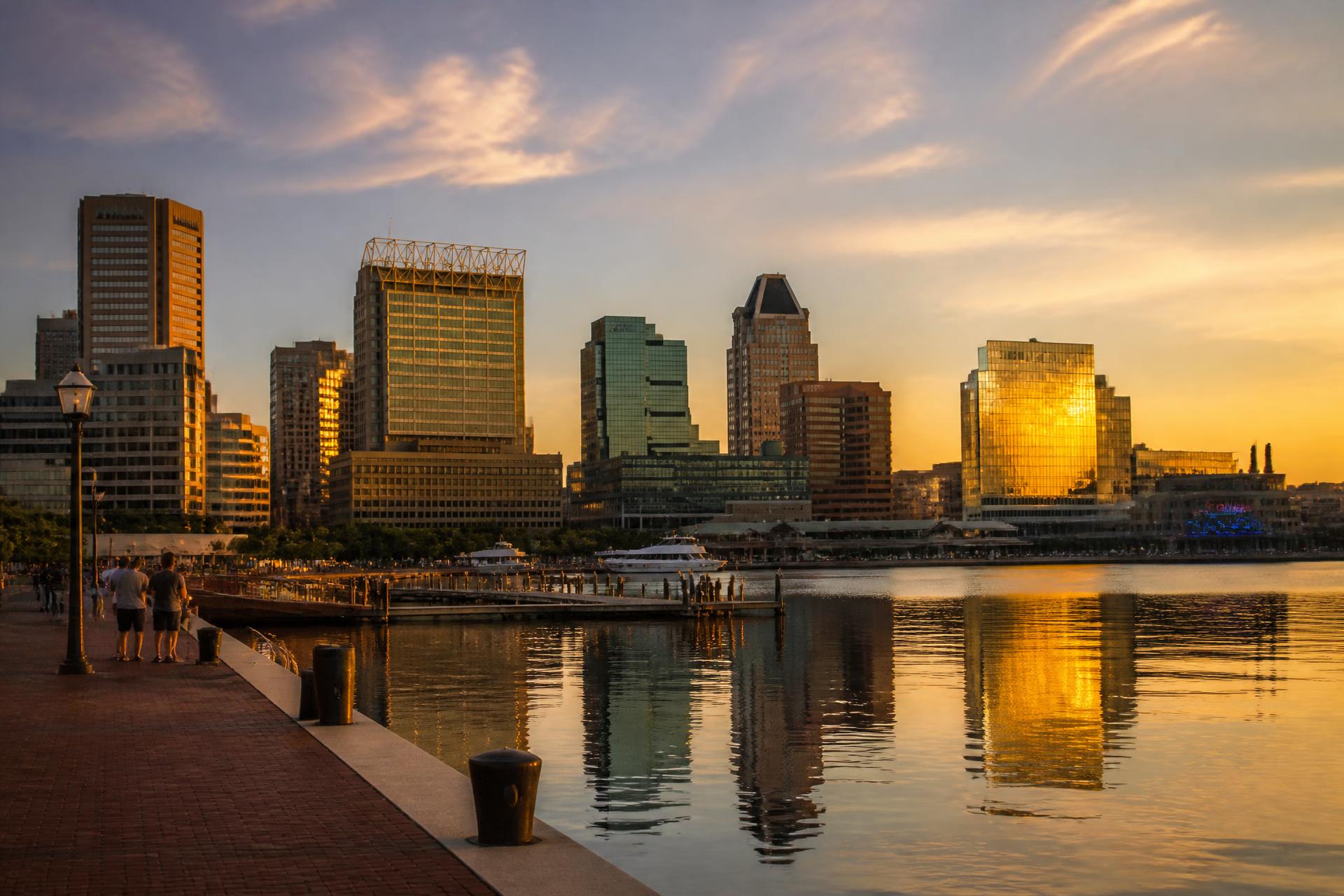 Baltimore Inner Harbor skyline reflected in the water at golden hour
